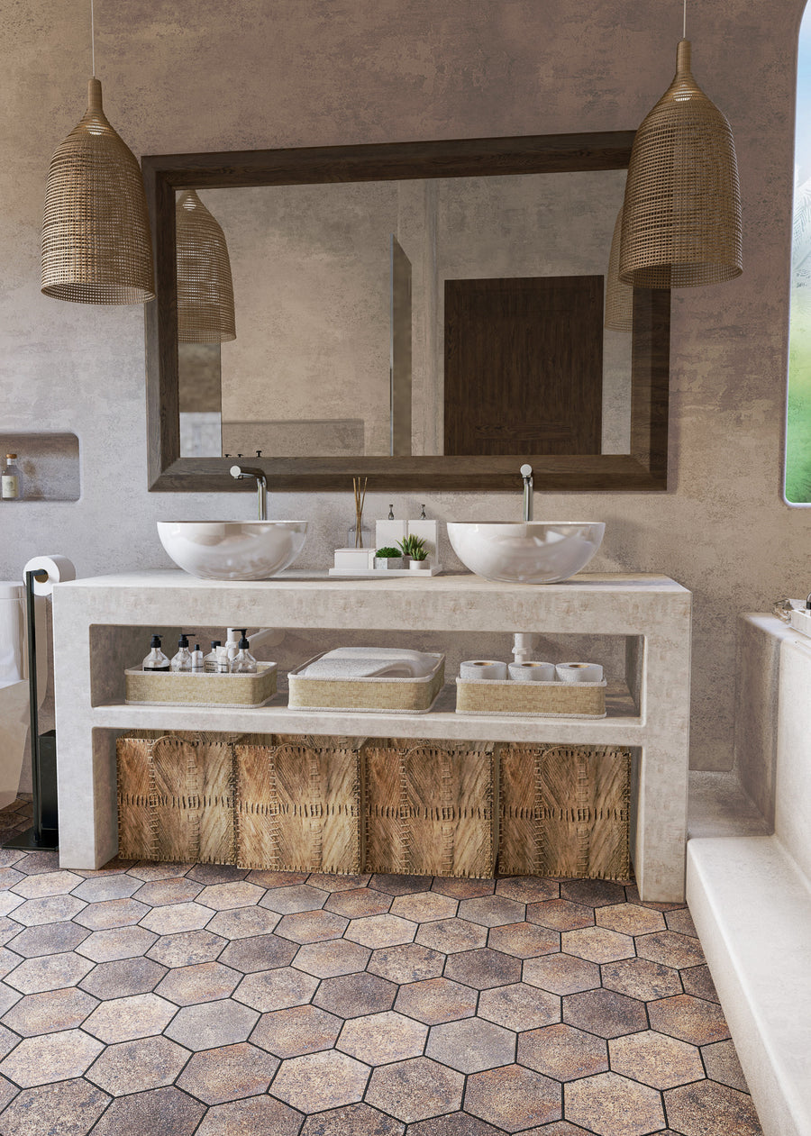 A modern bathroom with a large mirror, double sinks, woven pendant lights, hexagon tile floor, and open shelving with wicker baskets and neatly arranged toiletries.