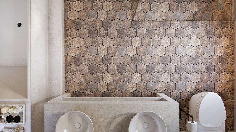 Modern bathroom with a hexagonal tile accent wall, two white vessel sinks on a concrete vanity, a white toilet, and shelves with rolled towels on the left. The design is minimal and neutral-toned.