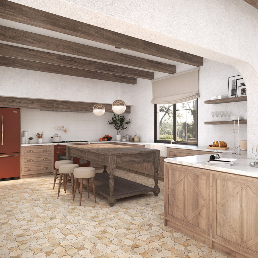 A spacious rustic kitchen with wooden beams, a large wood island, beige tiled floor, red refrigerator, open shelves, and countertops with various kitchen items. Natural light enters through a window with a roman shade.