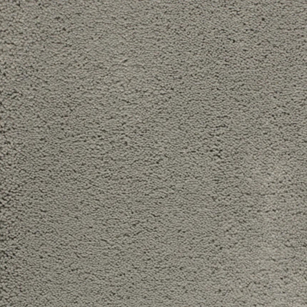 Close-up of Dolce Family Friendly Carpet in Thundercloud, featuring a textured, gray surface with subtle variations—reminiscent of durable finishes for high-traffic, modern interiors.