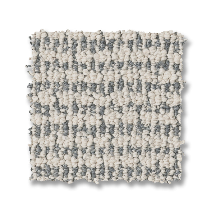 Laine On Trend Carpet features a square sample with a looped, chunky weave in cream and gray stripes. Its soft, thick fibers create a cozy, patterned surface that adds luxury style to any space.
