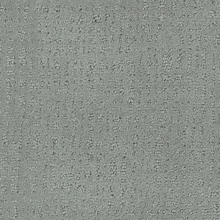 Close-up of Homage Berber Carpet in Tiffany color, showcasing a textured surface with raised rectangular and square shapes in an irregular grid—durable for high-traffic areas and adding refined style to any space.