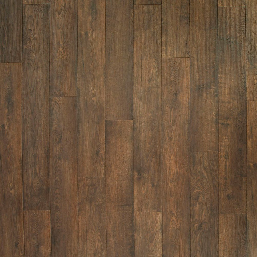 A close-up of Western Row 6 1/8' Waterproof Laminate in Tilled Oak highlights the rich wood grain, color variations, and textured detail for a premium flooring look.