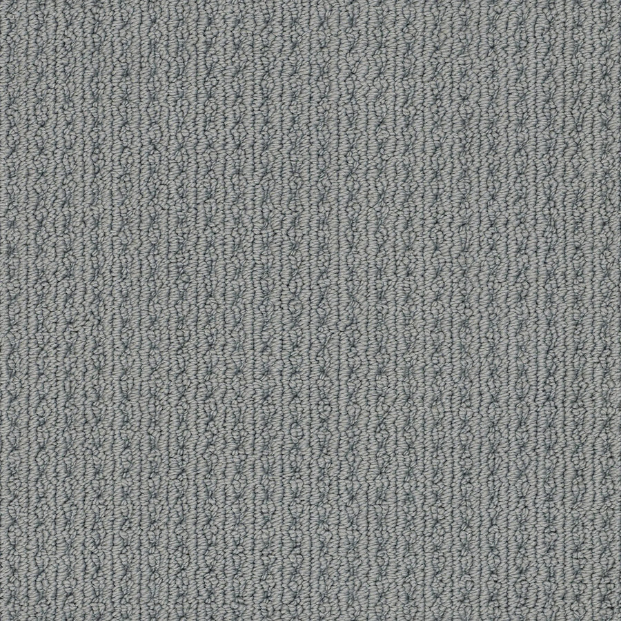 Close-up of San Lucas Family Friendly Carpet in Tin, featuring a textured, looped pattern with vertical ridges and subtle gray variations—perfect for high-traffic homes needing comfort and durability.