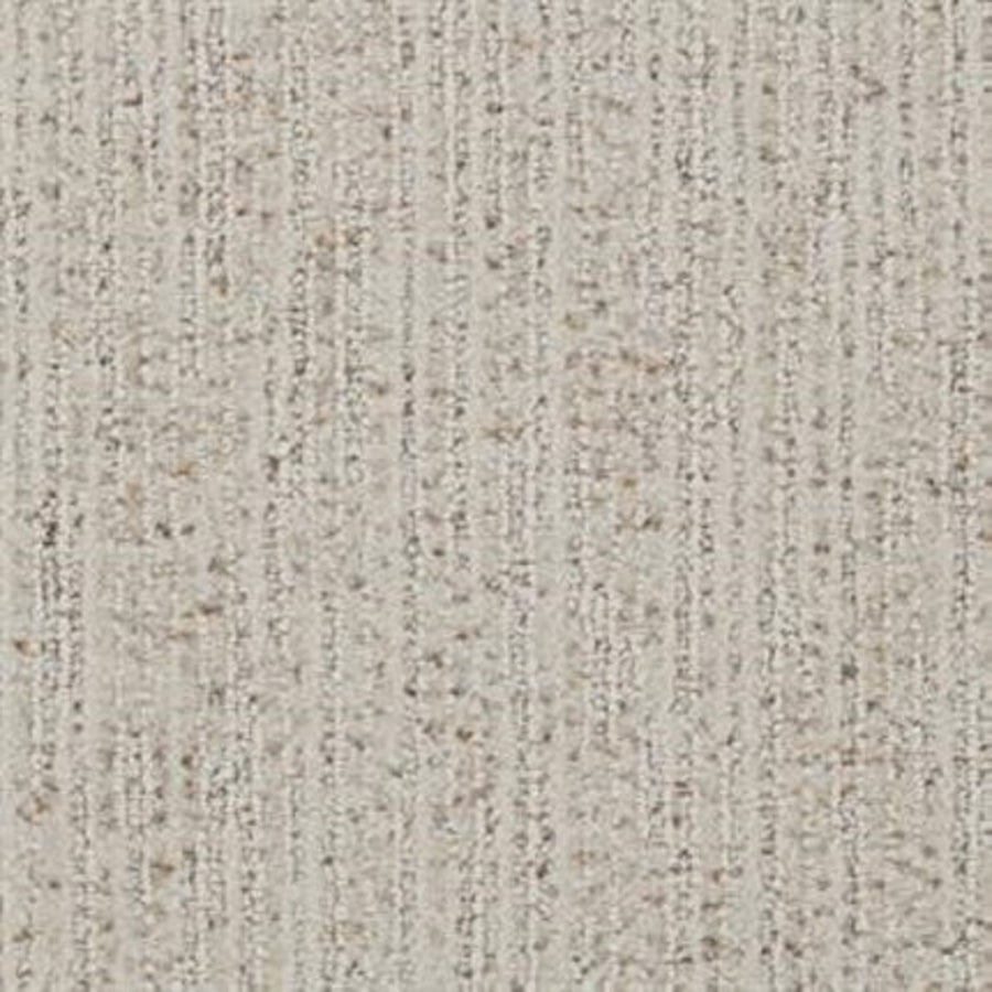 Close-up of the Suspicion Family Friendly Carpet in Tinge, showing a durable light beige surface with subtle vertical lines and darker fiber specks throughout.