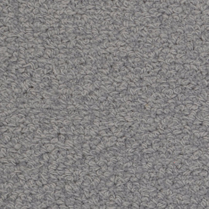 Close-up of Savant Berber Carpet in Torrone, featuring a light gray, textured loop-pile surface with uniform, slightly bumpy patterns. Its durable design makes it an ideal choice for high-traffic areas.