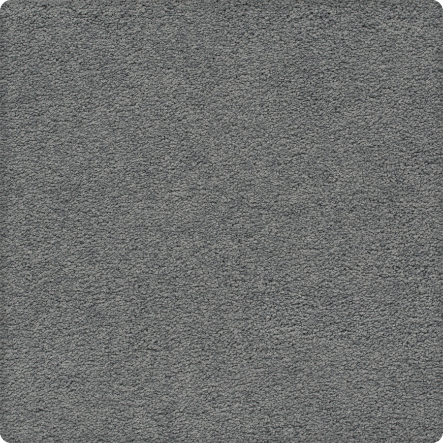 A close-up of the Traditional Cheer Pet Friendly Carpet in Lyric shows its gray, textured, stain-resistant surface with a soft, uniform look and rounded corners.