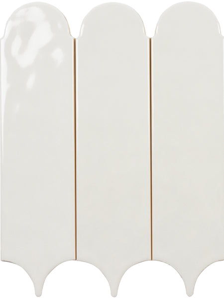 Three Tranquill 3x12 Glazed Ceramic Tiles, featuring a glossy off-white finish, are placed side by side. Each has a rounded top and scalloped bottom, forming an arched, decorative pattern with timeless appeal.