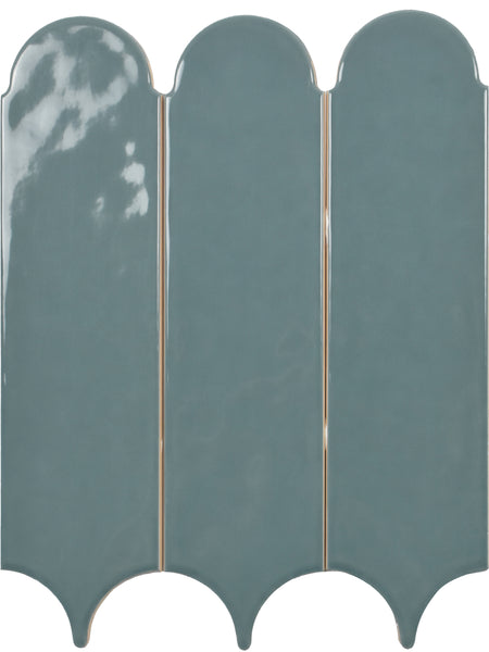 Three Tranquill 3x12 glazed ceramic tiles with a glossy teal finish and scalloped edges are aligned vertically against a white background, creating a timeless look.