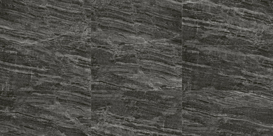 Cosmic 12x24 Rectified Porcelain Tile features dark gray hues with horizontal, wavy streaks. Grid arrangement, subtle texture, and shading create a natural look, while rectified edges provide a sleek, modern finish.