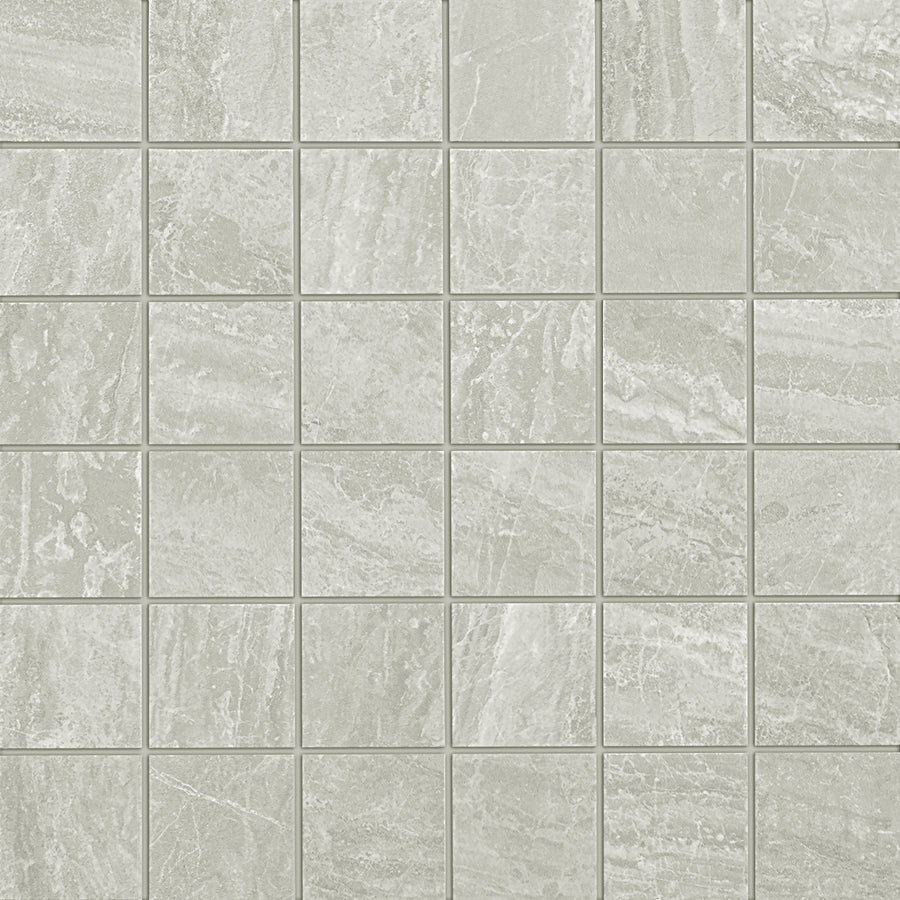 The Cosmic 2x2 Mosaic features light gray square tiles with a subtle marbled pattern and a lightly textured surface, arranged in an even grid with thin grout lines for an elegant finish in luxury floor tile installations.