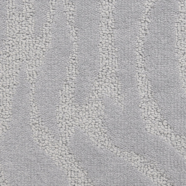 Close-up of Capetown On Trend Carpet in Victoria Basin, a light gray hue with a subtle wave-like pattern from raised looped fibers. This luxury carpet brings depth, movement, and comfort to high-traffic areas while elevating your style.