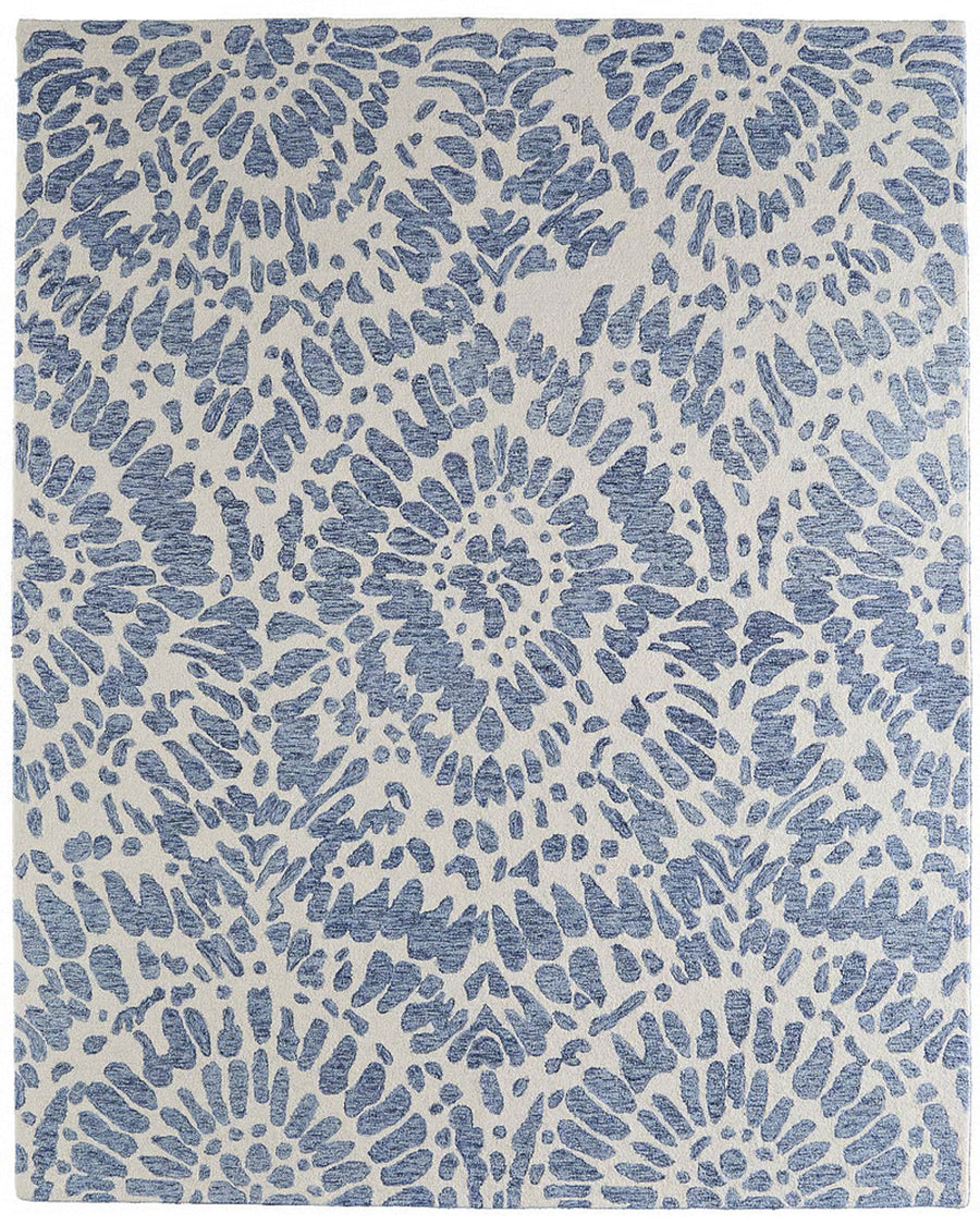 The Wallace 8A39F Area Rug showcases an elegant blue and white geometric design with floral-inspired mandala patterns, bringing symmetrical style across its rectangular surface.