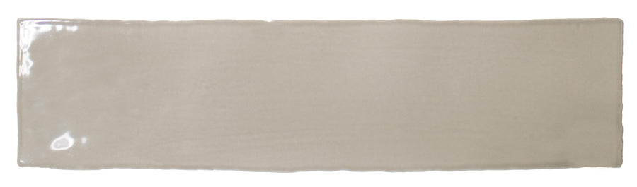 The Bali 3x12 Ceramic Subway Tile is a rectangular, glossy beige tile with slightly uneven edges, ideal for bringing a touch of luxury to any space. Shown here against a white background.