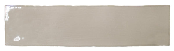 The Bali 3x12 Ceramic Subway Tile is a rectangular, glossy beige tile with slightly uneven edges, ideal for bringing a touch of luxury to any space. Shown here against a white background.
