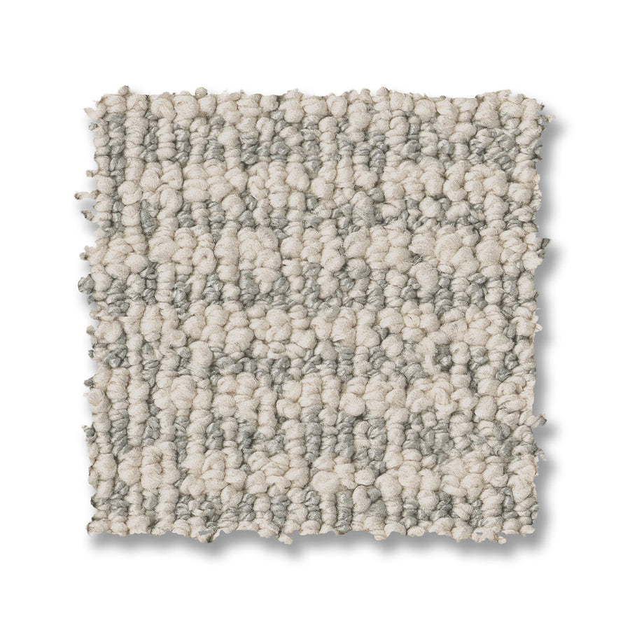 A square swatch of Laine On Trend Carpet shown in a loop-pile design with light beige and gray tones, displayed on a white background for a premium look.