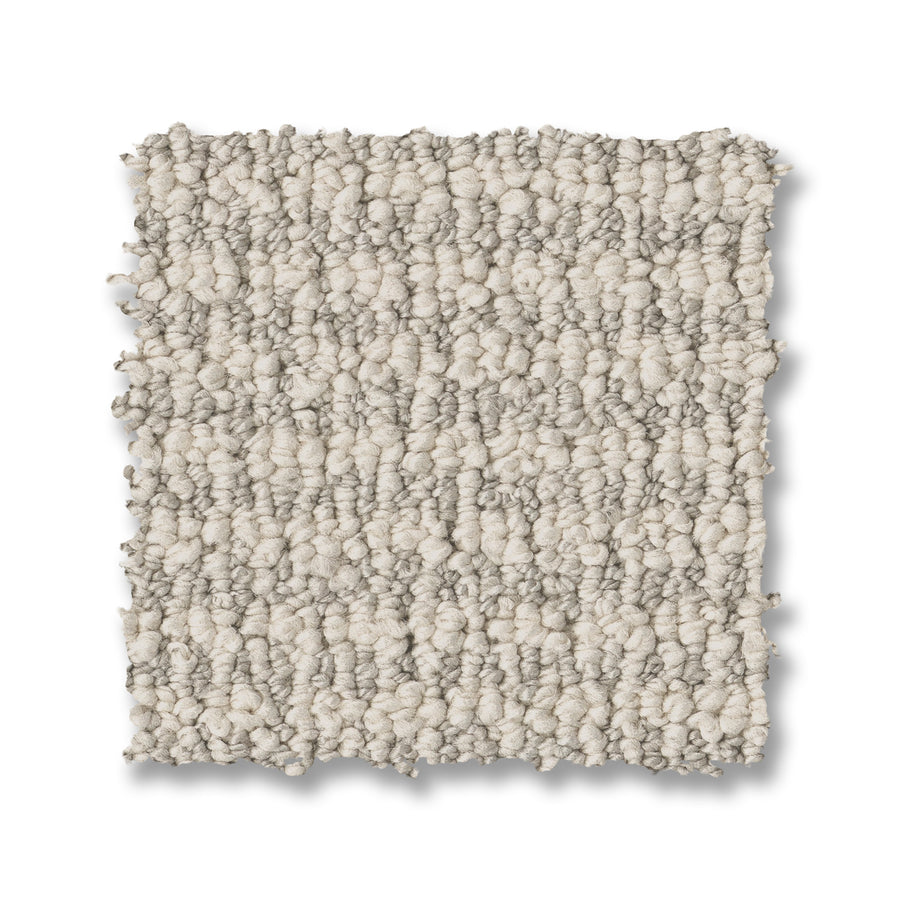 A square swatch of Laine On Trend Carpet in light beige rests on a white background, showing its soft, bumpy surface and small, dense loops for a cozy, textured appearance.