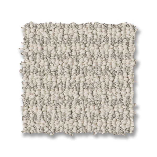A square swatch of Laine On Trend Carpet in light beige rests on a white background, showing its soft, bumpy surface and small, dense loops for a cozy, textured appearance.