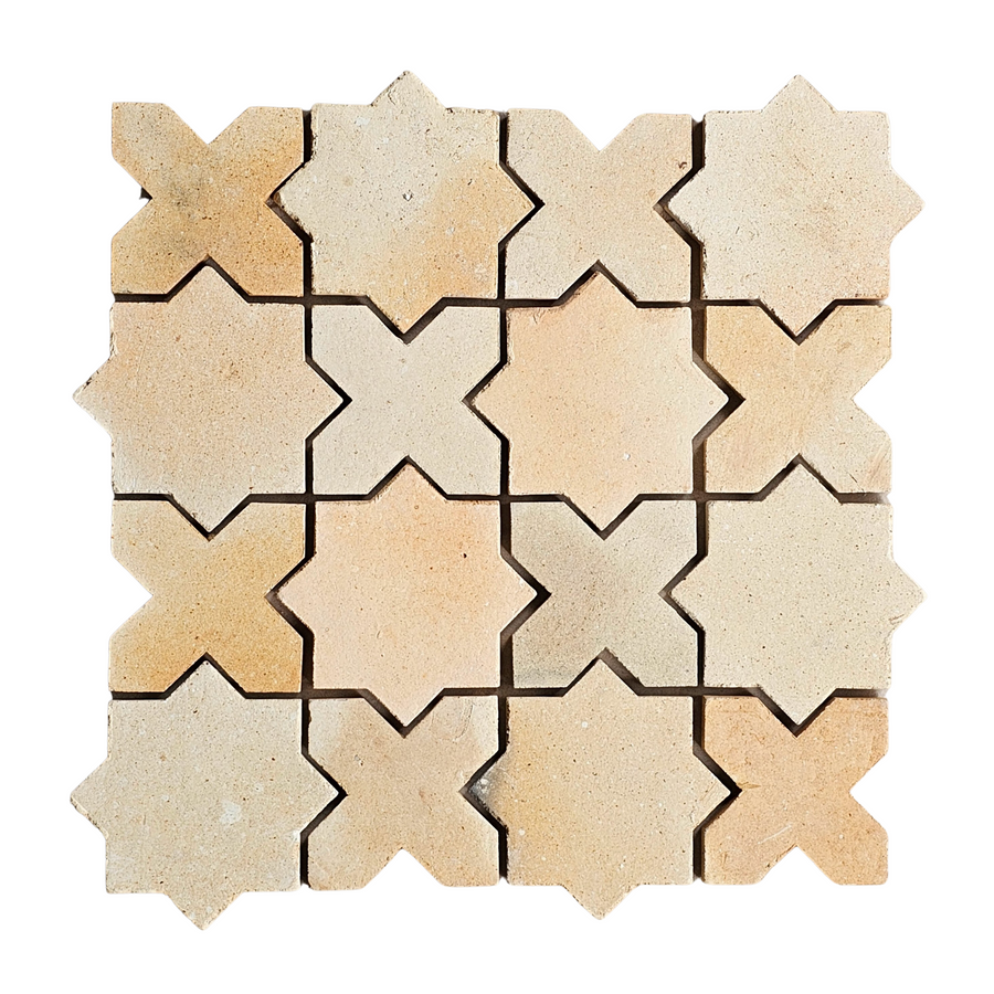 A top view of Atelier Clay XOXO Mosaic Natural Stone tiles, arranged in a square pattern with alternating star and cross shapes, fitting closely to create a beige geometric mosaic design.