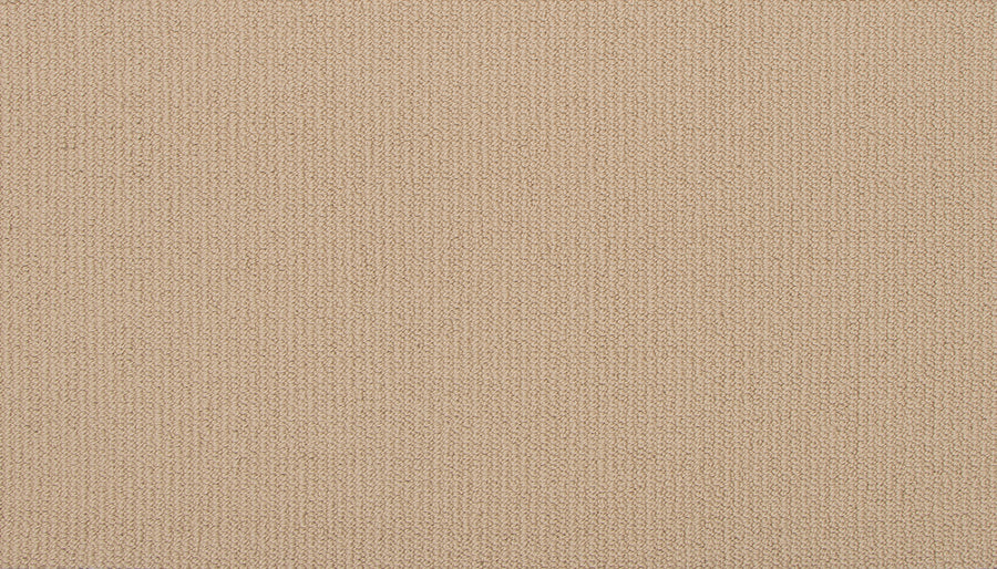 Close-up of Wool Fundamentals On Trend Carpet in Sandstone, showing its beige woven fabric with fine threads and an even, subtle texture—perfect for those seeking a stylish and durable wool carpeting option.