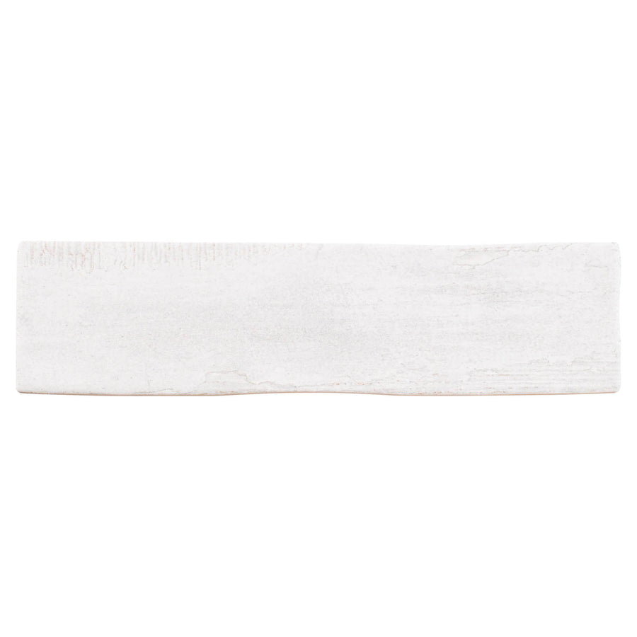 The Rhythmique 3" x 12" Ceramic Subway Tile in White features a subtly textured, uneven surface with rough edges—ideal for modern interiors or achieving a contemporary subway plank look.