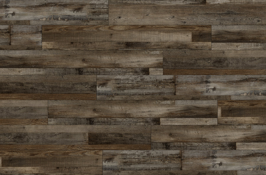 A close-up view of a wood plank floor pattern with varying shades of brown and gray, showing natural grain and texture on each rectangular plank arranged in a staggered layout.