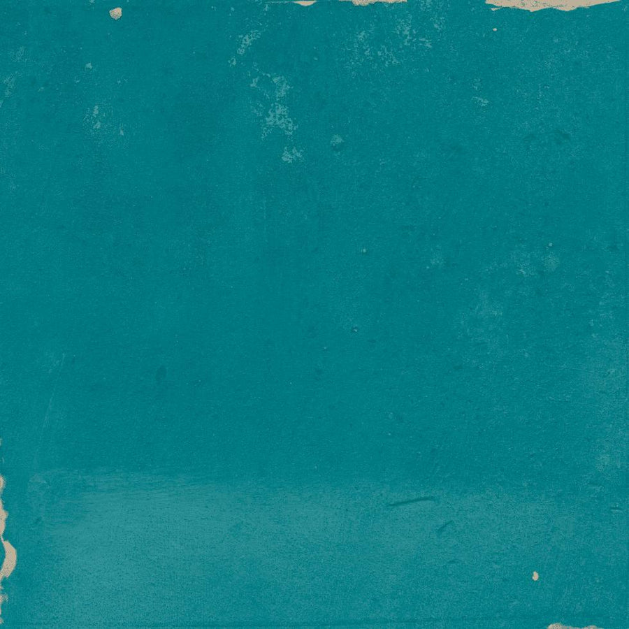 A textured teal surface with worn, rough edges and some small patches of exposed beige underneath, giving it a distressed, weathered appearance.