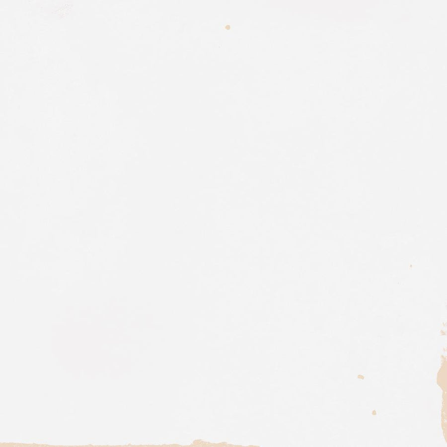 White background with a few small light brown stains and smudges scattered across the surface, mostly near the edges and corners. The image has an overall minimal and slightly textured appearance.