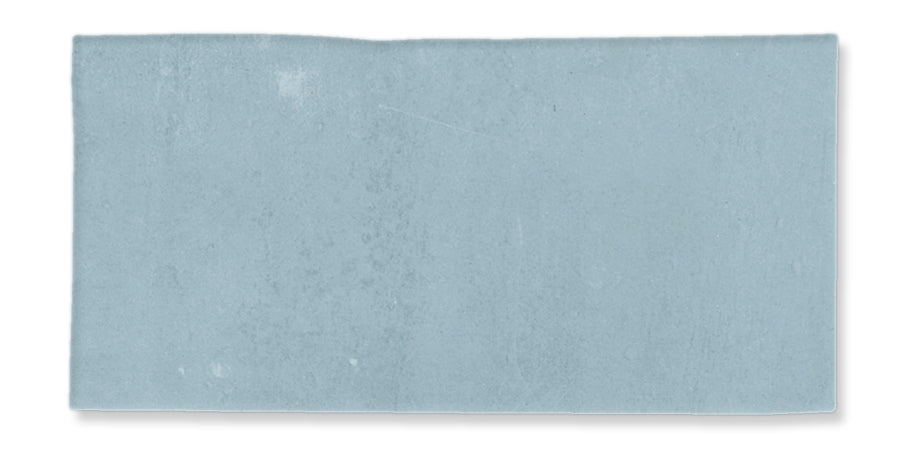 A rectangular piece of light blue paper with a slightly uneven top edge and subtle texture, isolated on a white background.