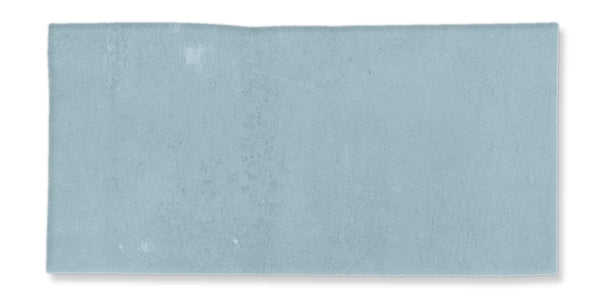 A rectangular piece of light blue paper with a slightly uneven top edge and subtle texture, isolated on a white background.
