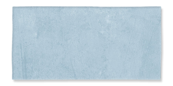 A rectangular tile with a smooth, matte light blue surface and subtle texture variation.