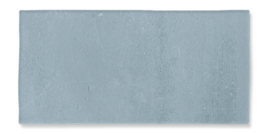 A rectangular, flat, light gray concrete tile with a slightly textured surface and subtle variations in shading.