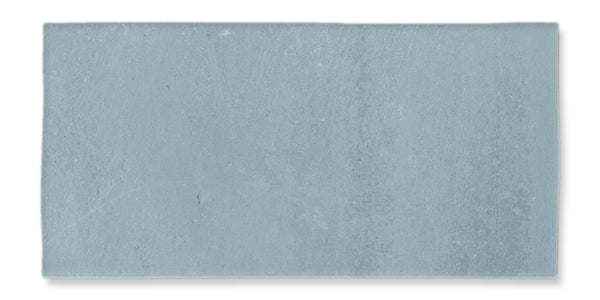 A rectangular, flat, light gray concrete tile with a slightly textured surface and subtle variations in shading.