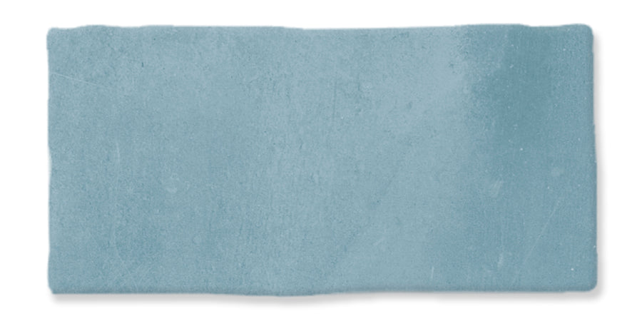 A rectangular piece of textured light blue paper with slightly uneven edges and faint variations in color.
