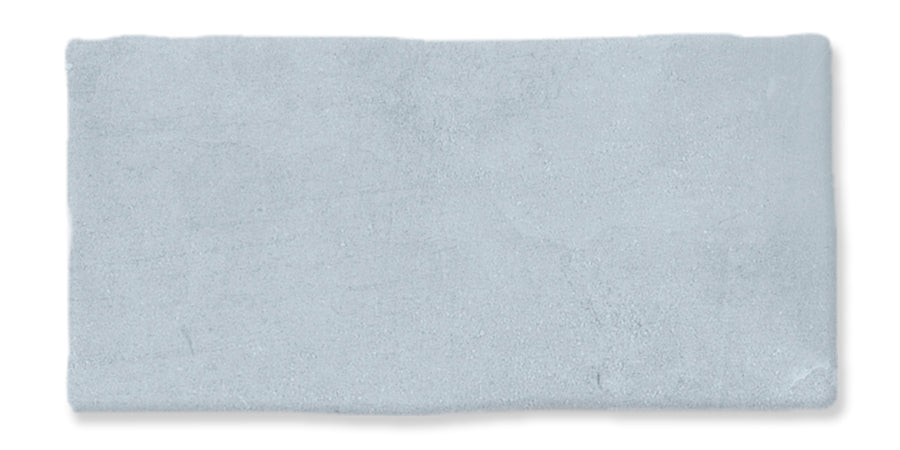 A rectangular, light gray tile with a slightly uneven, textured surface and rough edges, set against a white background.