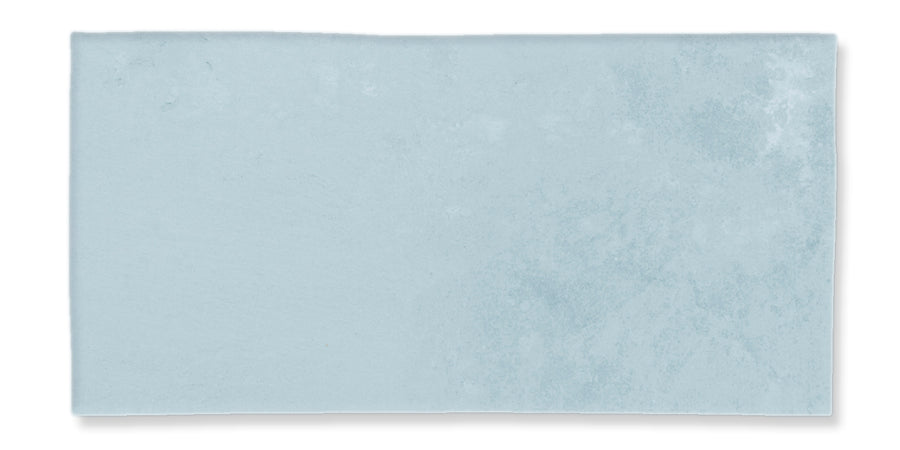 A rectangular, light blue tile with a subtle textured surface and slightly uneven edges, displayed against a white background.