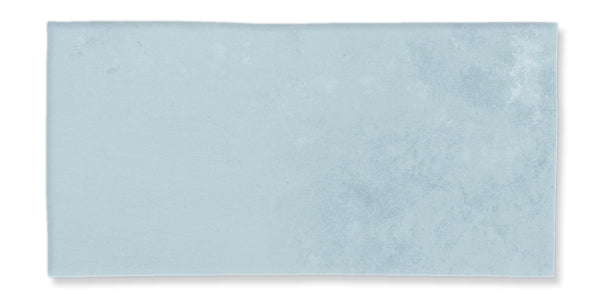 A rectangular, light blue tile with a subtle textured surface and slightly uneven edges, displayed against a white background.