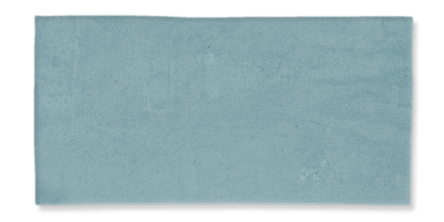 A rectangular, flat, light blue tile with a smooth, slightly mottled surface and clean edges, set against a white background.