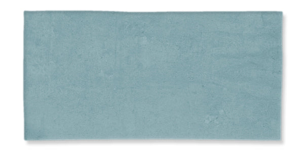 A rectangular, flat, light blue tile with a smooth, slightly mottled surface and clean edges, set against a white background.