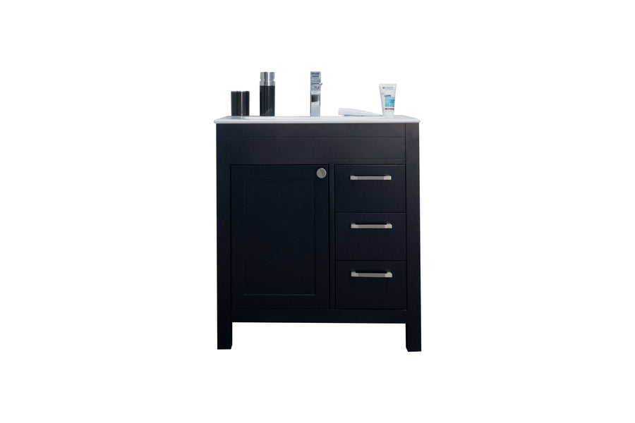 A black bathroom vanity with a white countertop, three drawers with silver handles on the right, a cabinet on the left, and various toiletries placed on top against a white background.