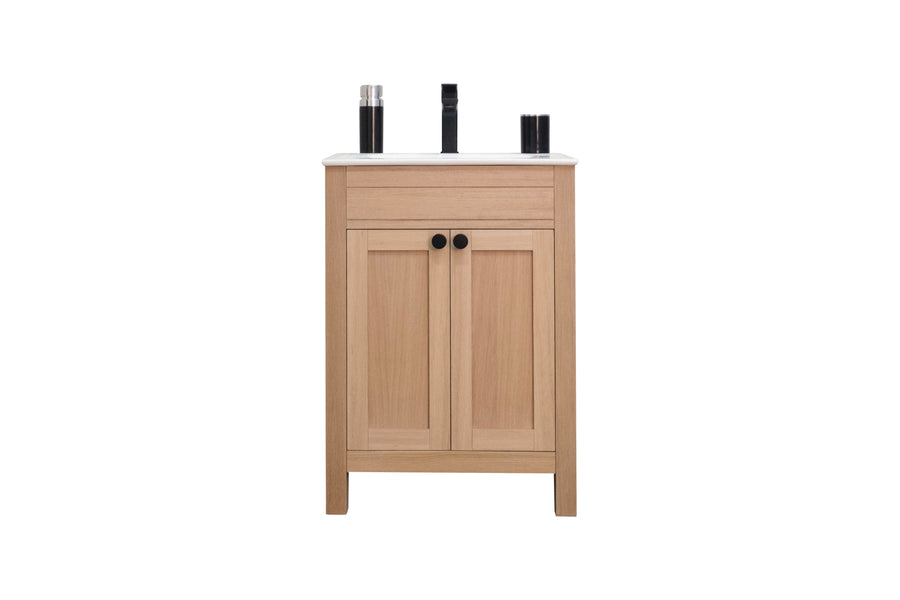 A wooden bathroom vanity with a white countertop, black faucet, and two black knob handles on the cabinet doors. Two black containers are placed on either side of the faucet.