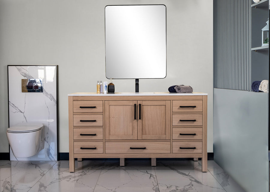 A modern bathroom showcases the Ashley 60" Vanity with black handles, a square mirror above, and a left-positioned toilet. White-gray marble patterned floors and partial walls contrast shelves of neatly rolled towels to the right.