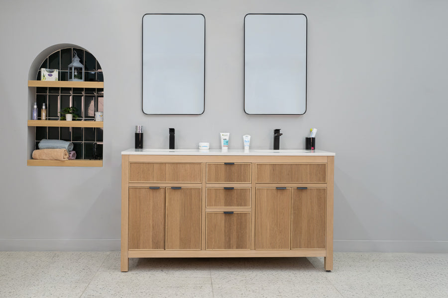 A modern bathroom includes the Catalina 60" Double Bowl Vanity with two rectangular mirrors above and an arched built-in shelf on the left for toiletries, towels, and a plant, all set against a light gray wall.