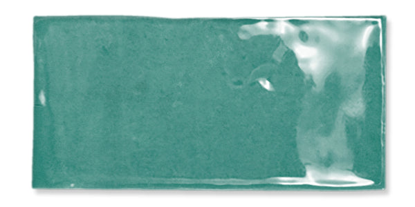 A rectangular teal ceramic tile with a glossy, uneven surface and slightly wavy edges, set against a white background.