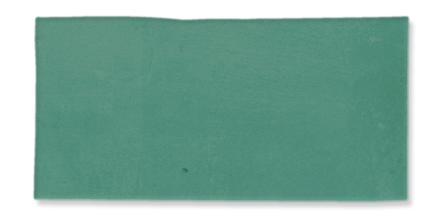 A rectangular, textured tile in a teal color with slightly uneven edges and a matte finish, set against a white background.