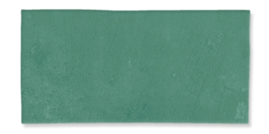 A rectangular teal-colored tile with a slightly textured, matte surface and subtle variations in shading.
