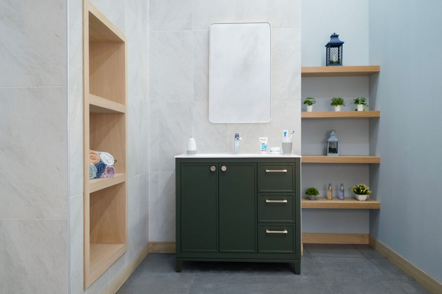 Modern bathroom featuring the Frame 36" Vanity in dark green with a white countertop, rectangular mirror, wooden shelves for plants and toiletries, a built-in cubby for rolled towels, and light tiled walls and floor.