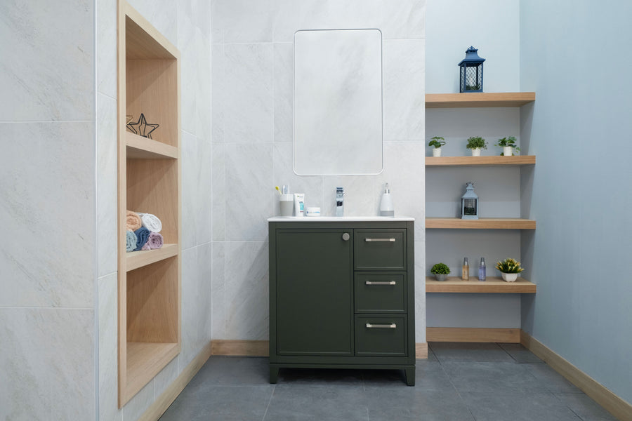Modern bathroom featuring the Frame 30" Vanity in green, paired with a mirror and open shelves for towels, toiletries, and plants. Neutral walls and floors give a clean, organized appearance.