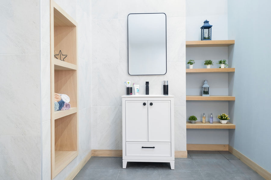 A stylish bathroom with a Frame 24" Vanity, rectangular mirror, floating shelves for plants and decor, a built-in towel shelf, light walls, and gray tile flooring creates a modern luxury look.
