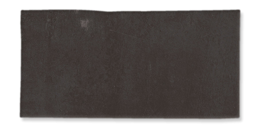 A rectangular, dark gray slate tile with a slightly uneven surface and rough edges, displayed against a white background.